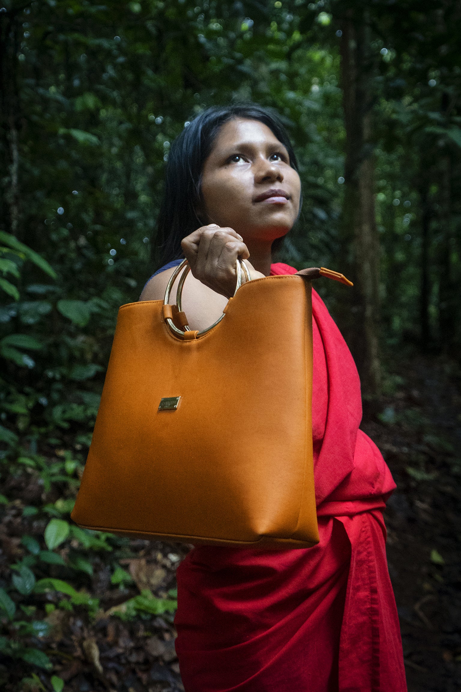 A Shiringa Bioleather bag pictured in the forest landscape that inspired it, showing how plant-derived innovation can offer an alternative to conventional animal leather.